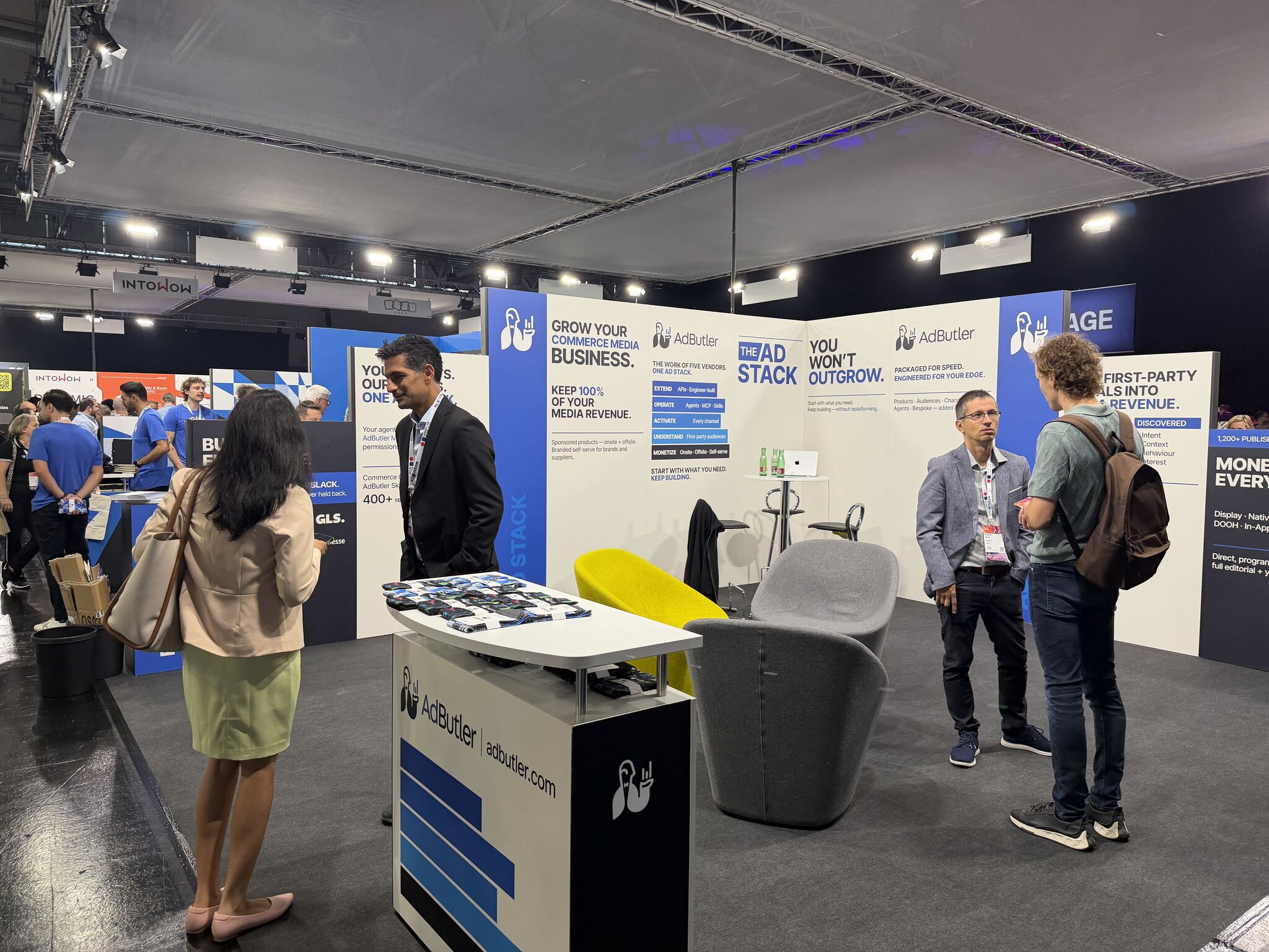 AdButler booth graphics at DMEXCO, with visitors on the exhibition floor